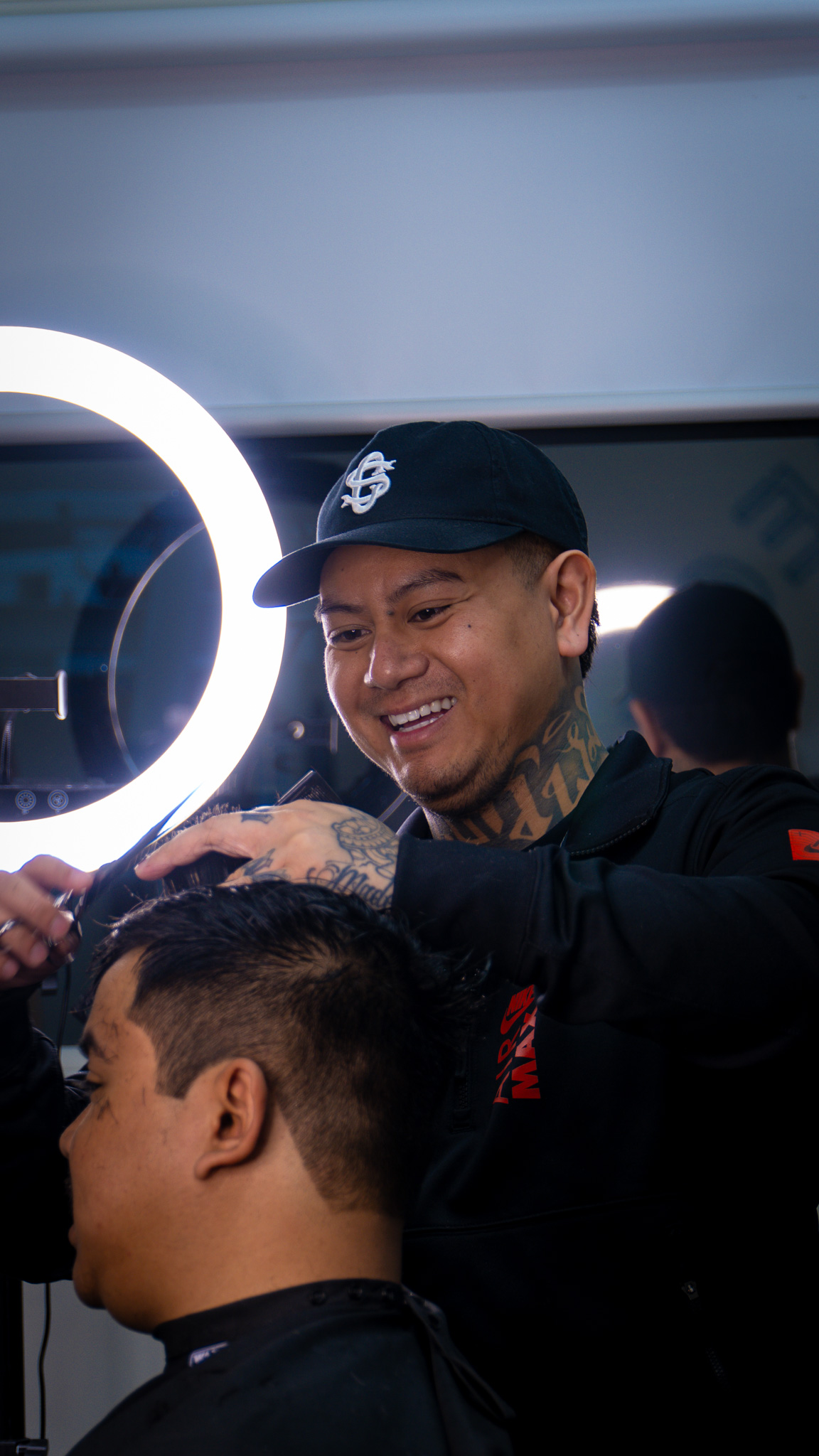 Barber cutting client's hair with scissors