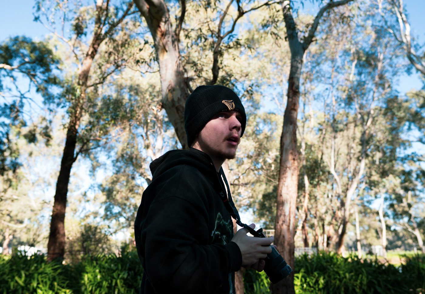 Shane Leigh holding a camera on location